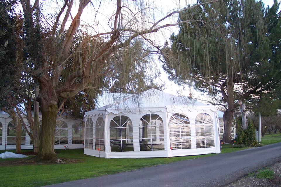 Our 26ft all white Gazebo provided a wing off of the main tent for an elegant circular buffet section. This tent can be used as a ceremony feature without walls. We have bunting for the legs. Added flowers and bows can be quite lovely.