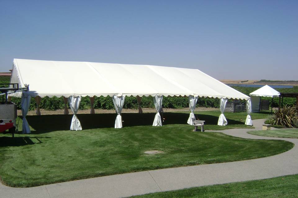 Pictured is our 50 x 60 White tent with bunting leg dressing.  We also have a 10 x 10 in the back ground that can be utilized for sign in, outdoor bar, or DJ area.