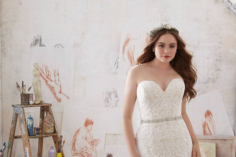 Mila, Style 3215	This Glamorous Fit & Flare Wedding Gown Features Frosted Alençon Lace Appliqués on Net. A Crystal Beaded Waistband and Soft Godet Pleats Add a Romantic Touch. Colors Available: White, Ivory, Ivory/Coco. Shown in Ivory/Coco.