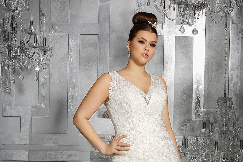 Minerva, Style 3223	Fit and Flare Gown Features Embroidered Appliqués and Exquisite Hemlace. Illusion Back and Button Detail. Available in Three Lengths: 55”, 58”, 61”. Colors Available: White, Ivory, Ivory/Light Gold.
