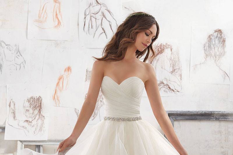 Marissa, Style 5504	This Dreamy Organza Ballgown Features a Flounced Skirt with Horsehair Trim. Removable Crystal Beaded Satin Belt Included. Available in: White, Ivory, Light Gold.