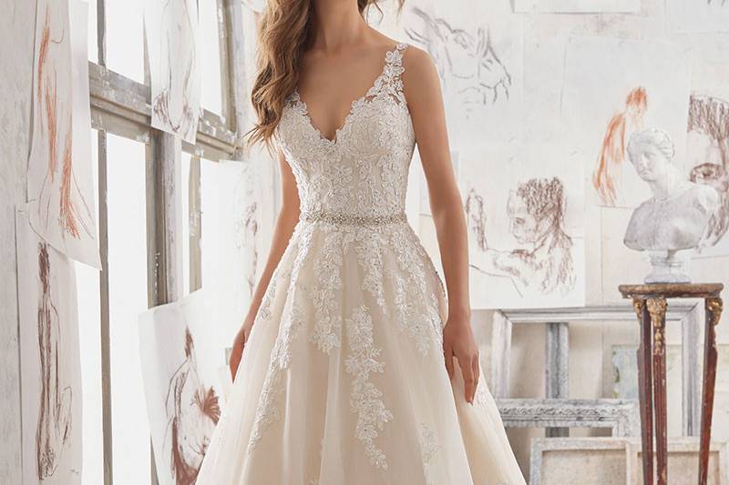 Martina, Style 5510	This A-Line Bridal Gown Features Crystal Beaded Alençon Lace Appliqués on Organza. Illusion Keyhole Back. Removable Beaded Belt Included. Available in: White, Ivory, Light Gold.