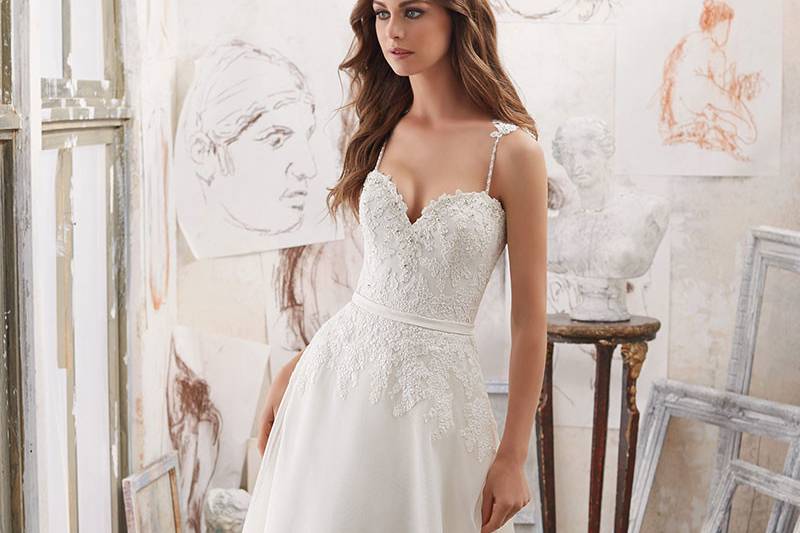 Marzena, Style 5514	This Chiffon A-Line Wedding Dress Combines Frosted Alençon Lace Appliqués, Diamante Trim, and Appliquéd Straps. The Corset Style Illusion Back is Accented with Buttons. Available in: White, Ivory.