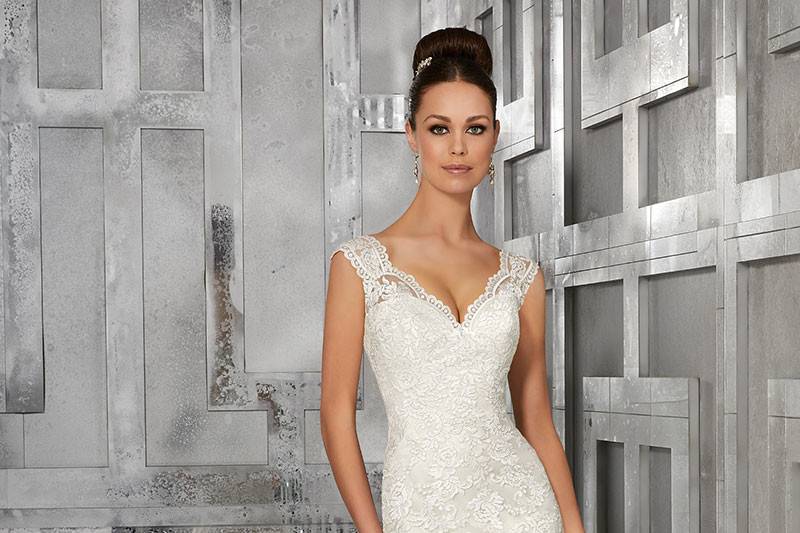 Monet, Style 5562	This Net Fit and Flare Wedding Dress Features Embroidered Appliqués & Scalloped Hemline. Embroidered Illusion Back. Shown with Detachable Tulle Train. Available in: White, Ivory, Ivory/Light Gold.