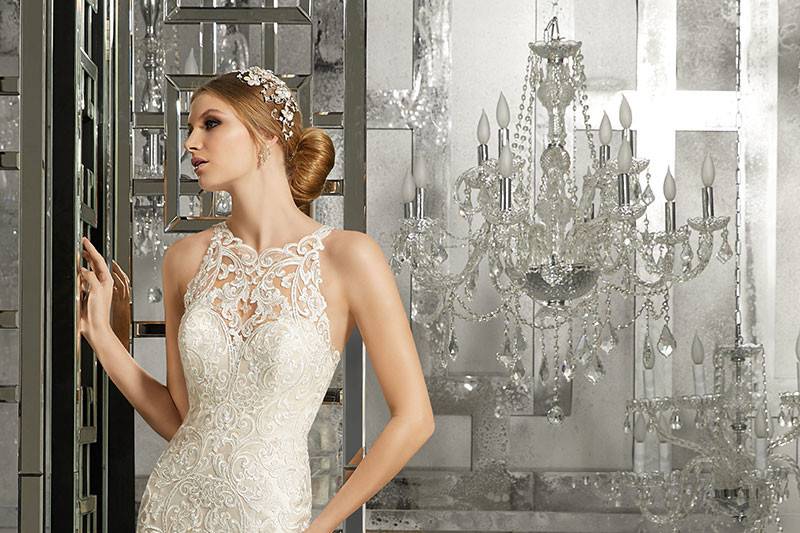 Mimi, Style 8173	Classic and Elegant, this Fit and Flare Wedding Gown Features Sculptured, Embroidered Appliqués with a Scalloped Hemline and Sheer Train. A Breathtaking Illusion Back. White, Ivory, Ivory/Light Gold.