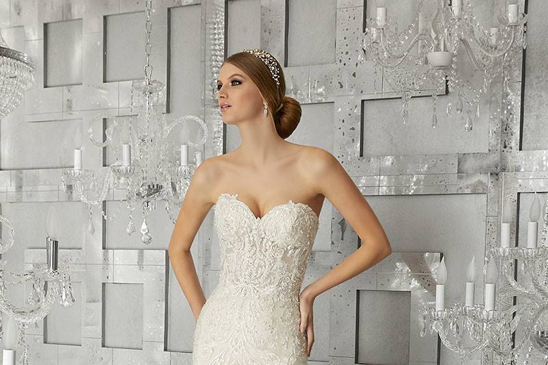 Muse, Style 8177	Sculptured, Embroidered Appliqués Sweetheart Neckline with Crystal Beading on Hand-Cut, Cascading Organza Ruffled Mermaid. Satin Bodice Lining Included. Available in White, Ivory, & Champagne.