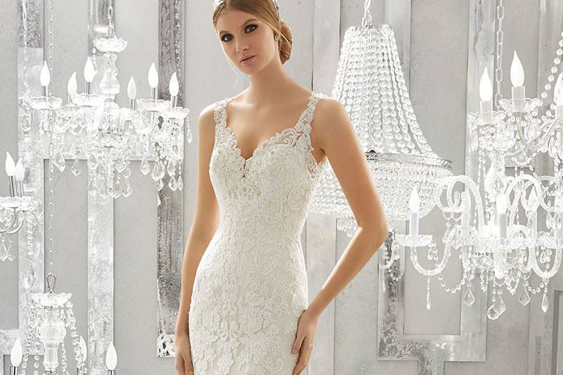 Meya, Style 8183	Romantic Frosted Alençon Lace Appliqués Create A Soft and Feminine Fit and Flare Wedding Gown. Scalloped Hemline Lace Complete and Open Keyhole Back. Colors Available: White, Ivory, Ivory/Light Gold.