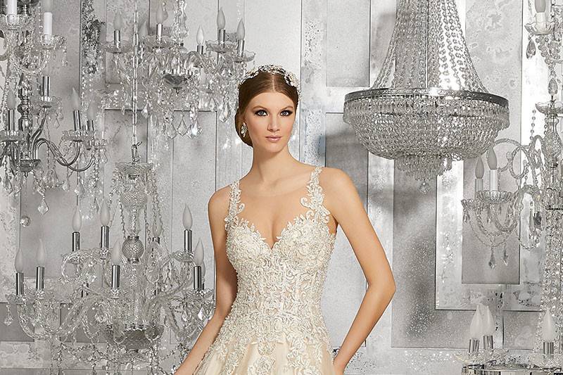 Mahala, Style 8190	Crystal Beaded Venice Lace Appliqués Accent the Sheer Neckline & Bodice. Tulle Over Sparkle Net Adds Dimension to the Skirt. Open Keyhole Back. Lining Included. Available in: White, Ivory, Light Gold.