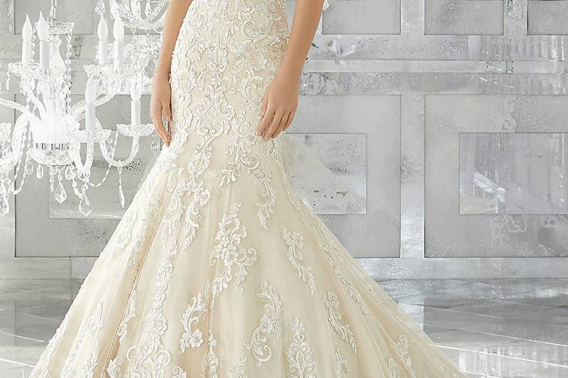 Melrose, Style 8193	Fit and Flare Wedding Gown Features Frosted, Embroidered Appliqués on Tulle Over Sparkle Net. Wide Scalloped Hemline & Sheer Back with Exposed Boning. Available in: White, Ivory, Light Gold.