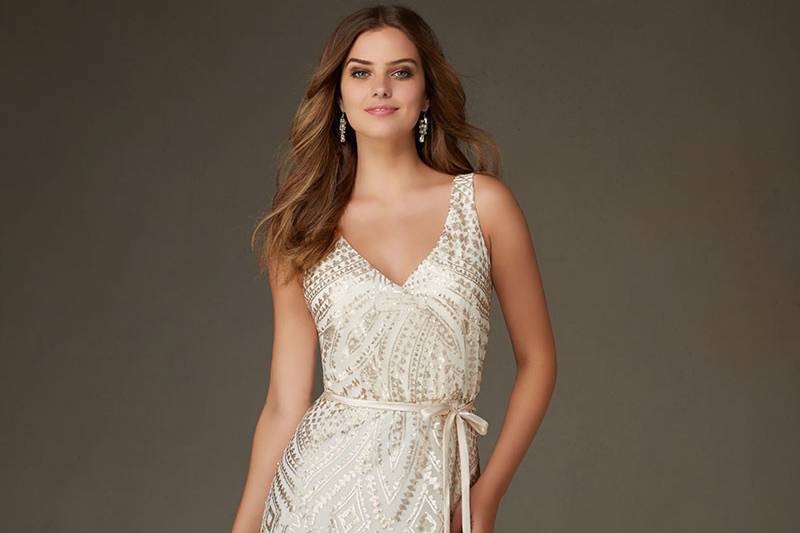 Style 20476	Patterned Sequin on Mesh Metallic Morilee Bridesmaid Dress. V Neckline and Back. Available in Champagne, Blush, Navy, and Taupe. Matching Satin Tie/ Sash Included.