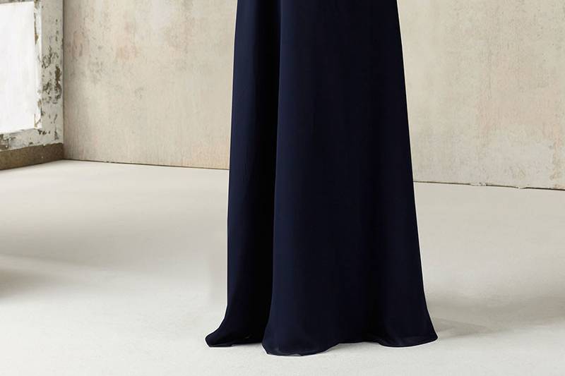 Style 21527	This Stunning Chiffon Bridesmaids Dress Features a Romantic Ruffled V Neckline and Open Keyhole Back. Zipper Back. Shown in Navy. Available in 34 colors.