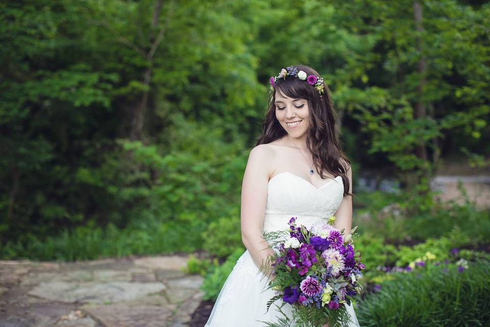 Bride holding purple bouquet