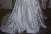 This wedding gown was transformed into the boy romper christening set pictured. There is enough of this gown to construct an additional traditional long christening gown.