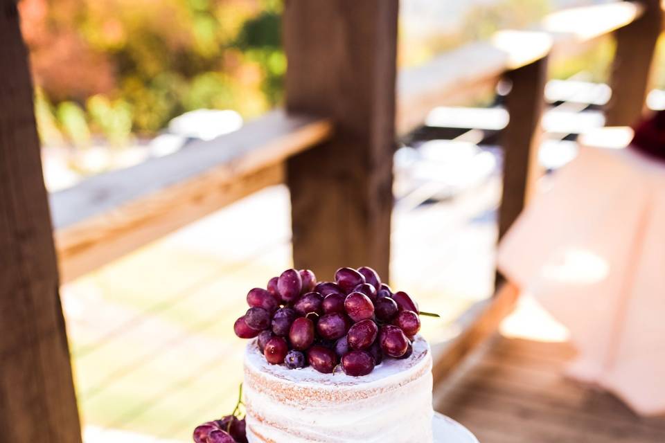 Naked wedding cake covered in berries