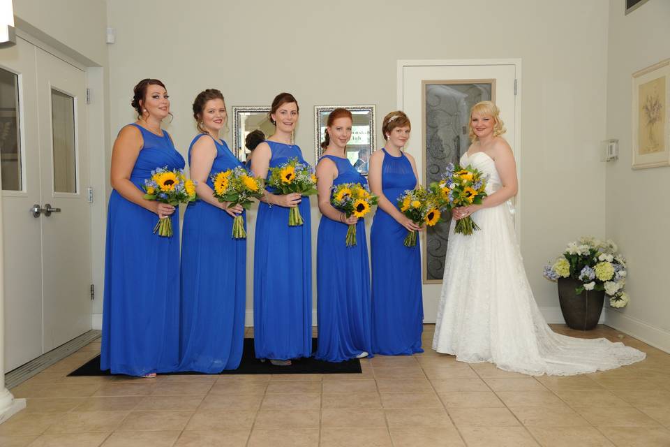 Blue dresses and sunflower bouquets