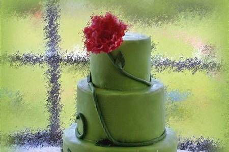 Whitney's cake popped with a cool kiwi green color with a green vine and leaves ending in a shocking pink gum paste peony.