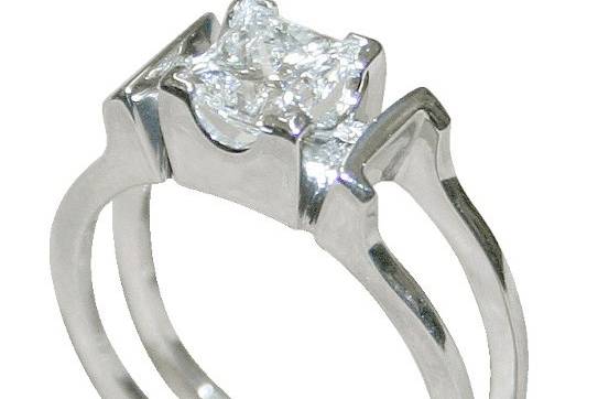 Contemporary wedding and engagement ring set with a center white diamond and platinum. Elegant and simple in design.