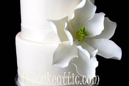 Large sugar Magnolia flower is the only decoration needed on this little cake.