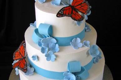 Buttercream cake with sugar flowers, ribbons and bows. Butterflies purchased by client.