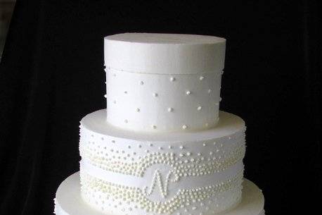 All buttercream cake with piped decorations.
