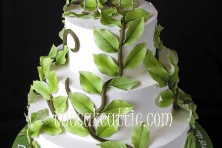 Buttercream cake with outdoor theme.  Sugar vines working their way up the cake. Cake topper purchased by client.