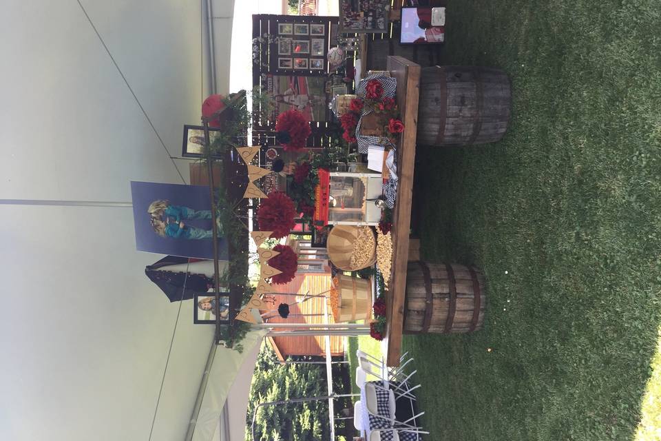 Popcorn bar using our wine barrels with antique bed frame suspended from the tent for memoribila