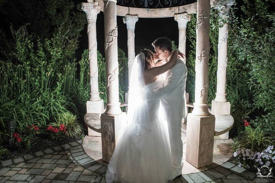 Newlyweds kissing at night