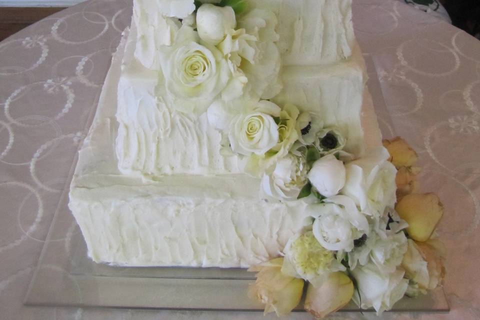 White cake with white floral decorations