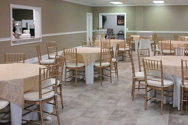 A small display of our gold ball room chairs with tables and table linens, all provided by Great American Tent.
