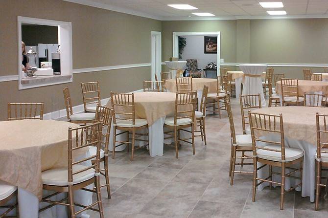 A small display of our gold ball room chairs with tables and table linens, all provided by Great American Tent.