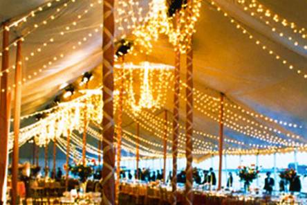 An old party we provided the tents, tables and chairs for. The lighting and ribbons were provided by the customer though. Our center poles are often used to hold lights and decorations.