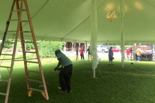 Pole covers and chandeliers go great with a high peak tent for lavish weddings.