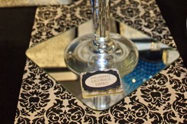 Foil-wrapped candies displayed in an oversized martini glass add shimmer and drama to the table.  Table runners are custom-made.