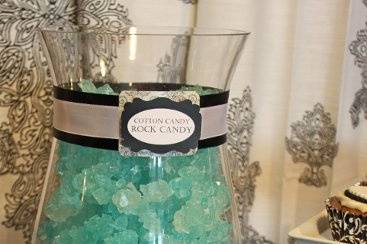 Rock candy adds sparkle and are a guest favorite.  Favor tins were custom-tagged to match the theme.
