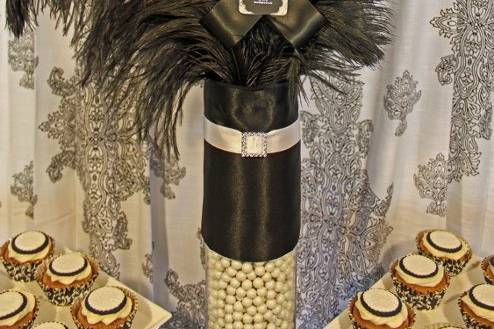 Custom centerpiece created for the buffet with black ostrich feathers, white turkey feathers, and handmade ribbon medallions.