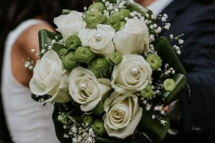 Sharing a kiss behind the bouquet