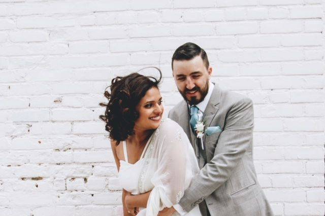 Groom embraces his bride