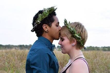 Groom kissing bride's forehead