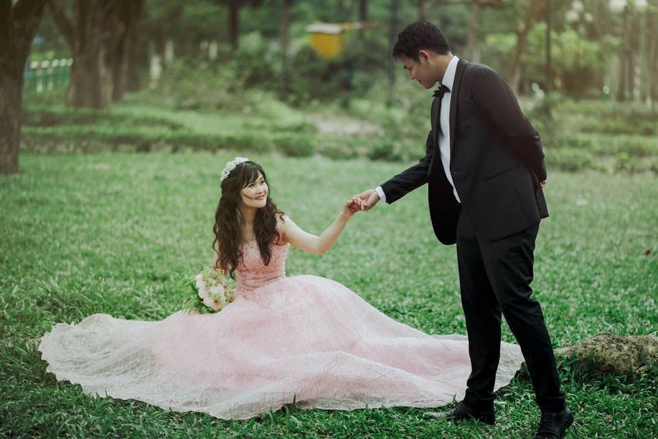 Groom helping his bride up