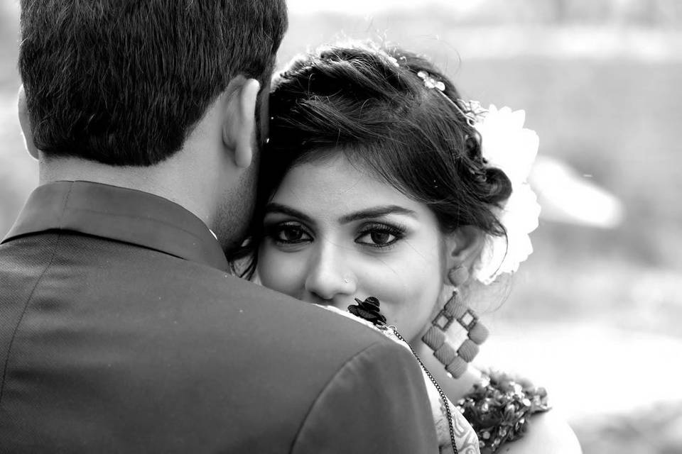Bride as she is embraced by her groom