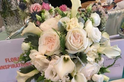 A cascade of fragrant and classic wedding flowers include garden roses, calla lilies and gardenias.  Garlands of white hyacinth blooms add to the sweet spring fragrance.