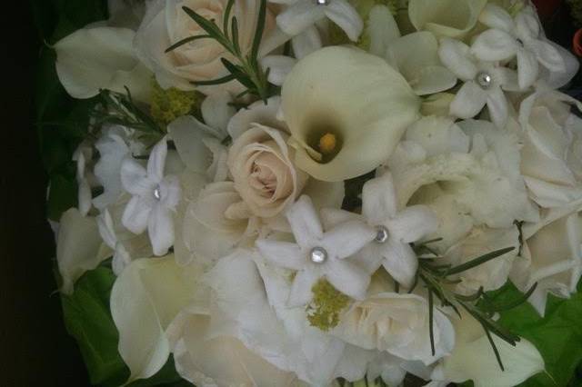 A classic bridal bouquet of calla lilies, stephanotis accented with cut crystals and roses.  Fresh rosemary adds to the fragrance to this bouquet.