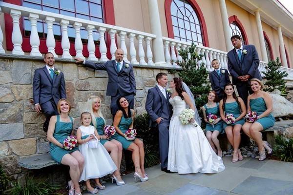 The couple with the bridesmaids and groomsmen and flower girl