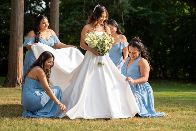 Bridal party at CV Rich Mansion, NYC – the bride and her bridesmaids in soft blue dresses share a beautiful moment together.