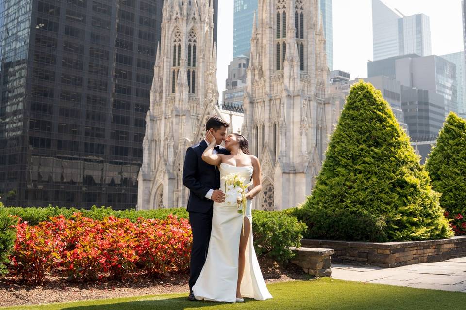 Couple portrait near 620 Loft & Garden, NYC – the newlyweds share a loving embrace in the iconic gardens near St. Patrick's Cathedral.