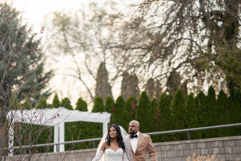Garden portrait at Swan Club on the Harbor, Roslyn, NY – a romantic portrait of the couple by the harbor-side gardens.
