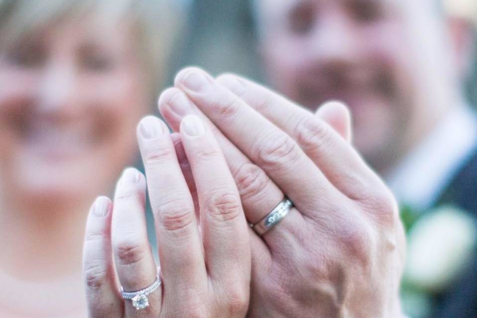 Couple showing off the wedding ring