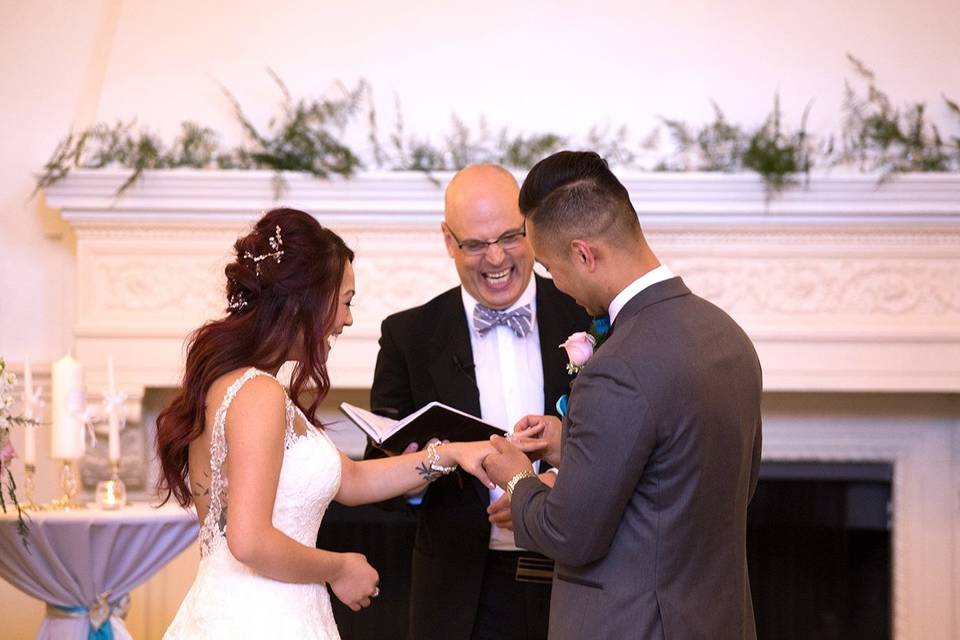 Happy officiant with the couple