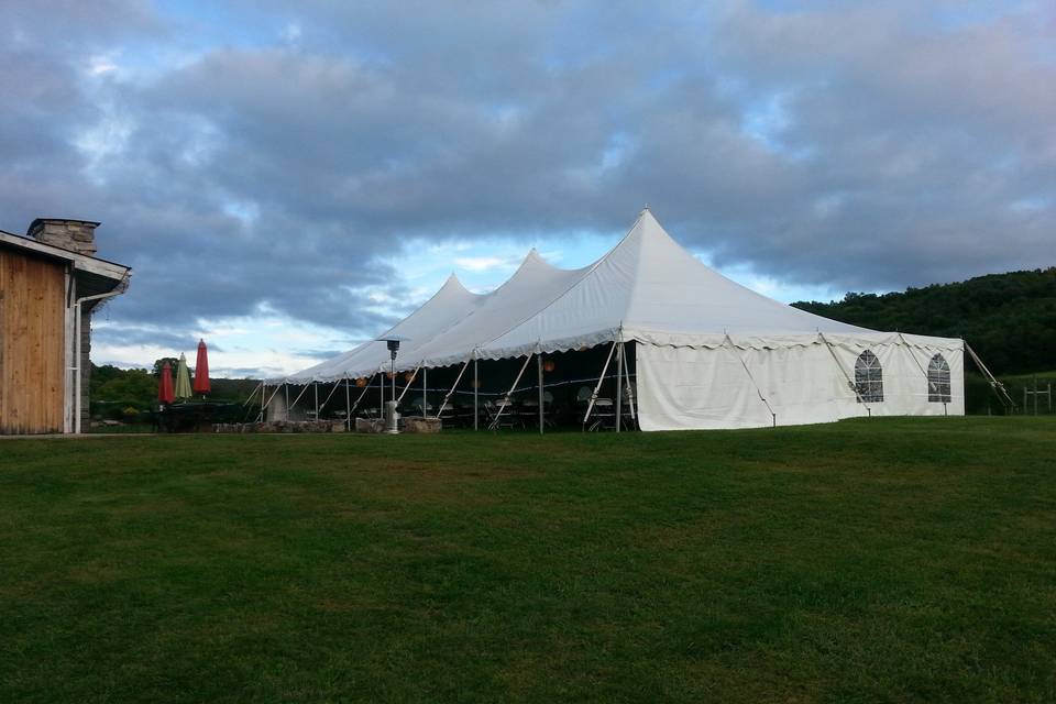 40x80 high peak set up for an autumn wedding with a solid and window walls and patio heaters