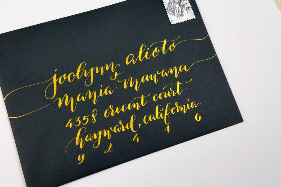 Beautiful envelope calligraphy on black envelope and gold ink by Paperloveme Calligraphy in California.